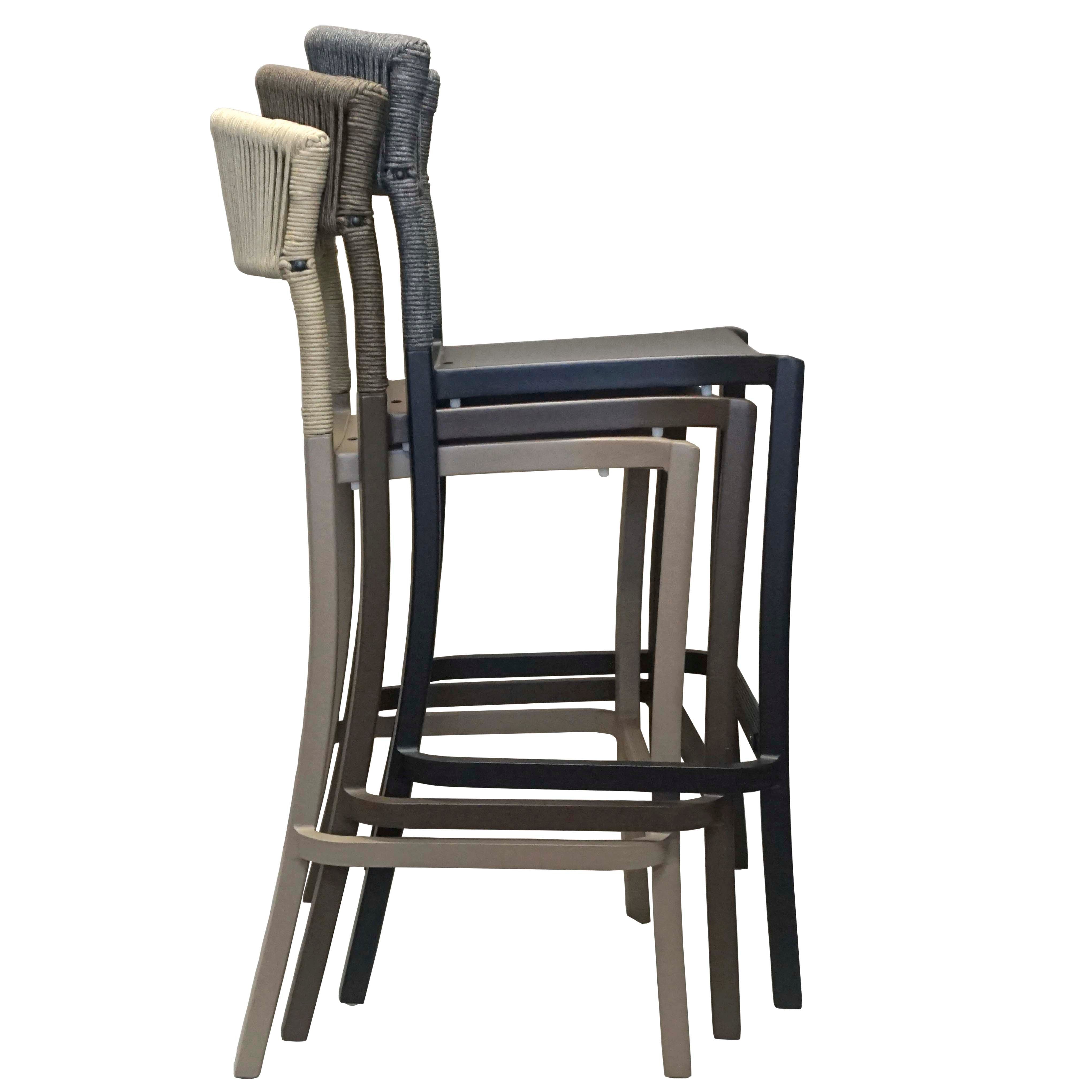 Stack of three bar stools with different finishes on a white background
