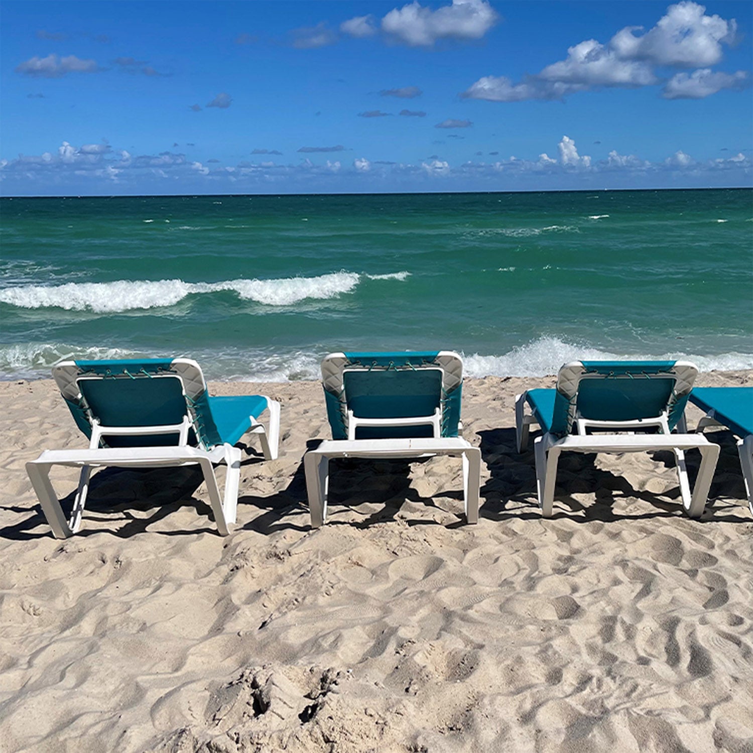 A line of Nautical Chaise Lounges overlooking the ocean