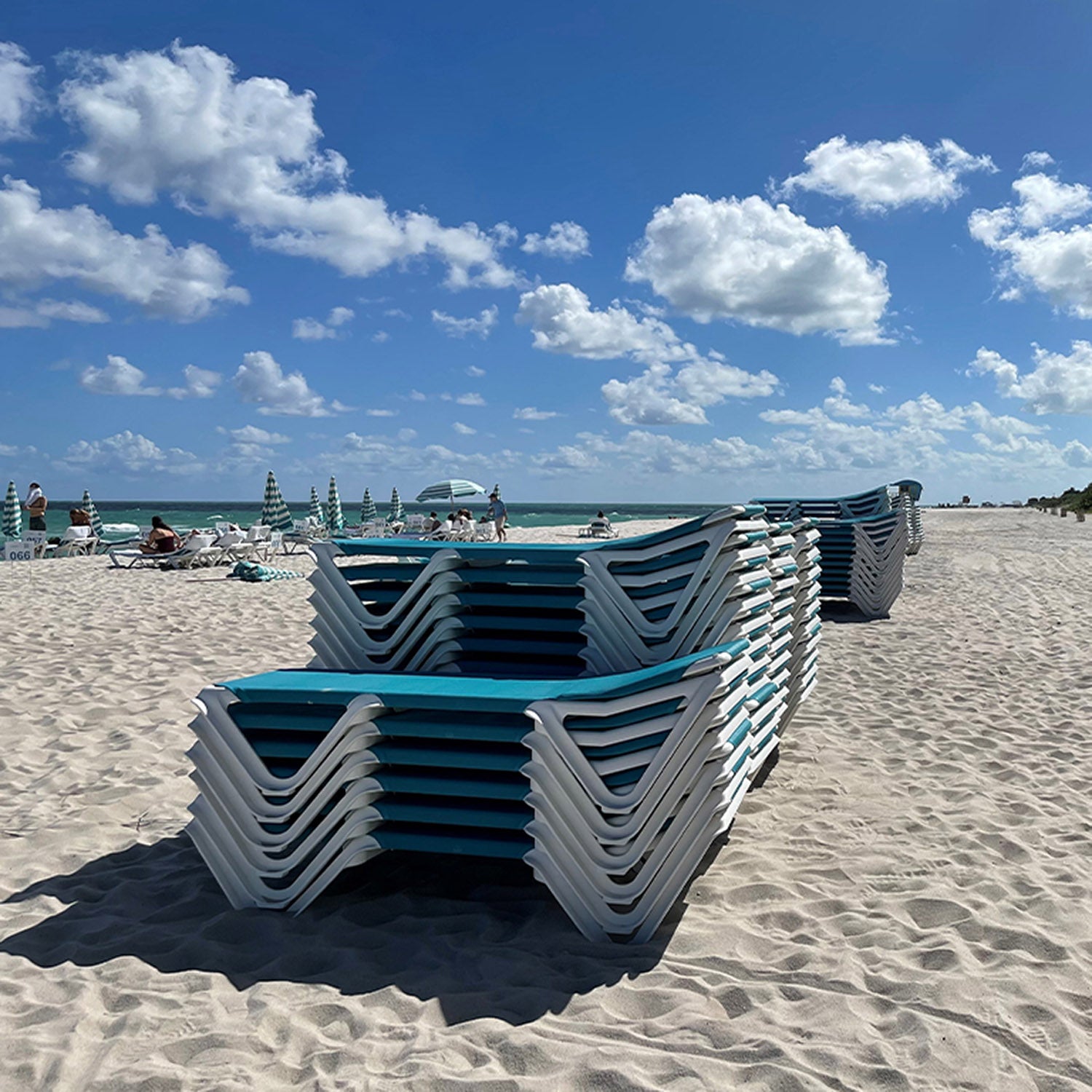 A group of Nautical Chaise Lounges stacking on the beach