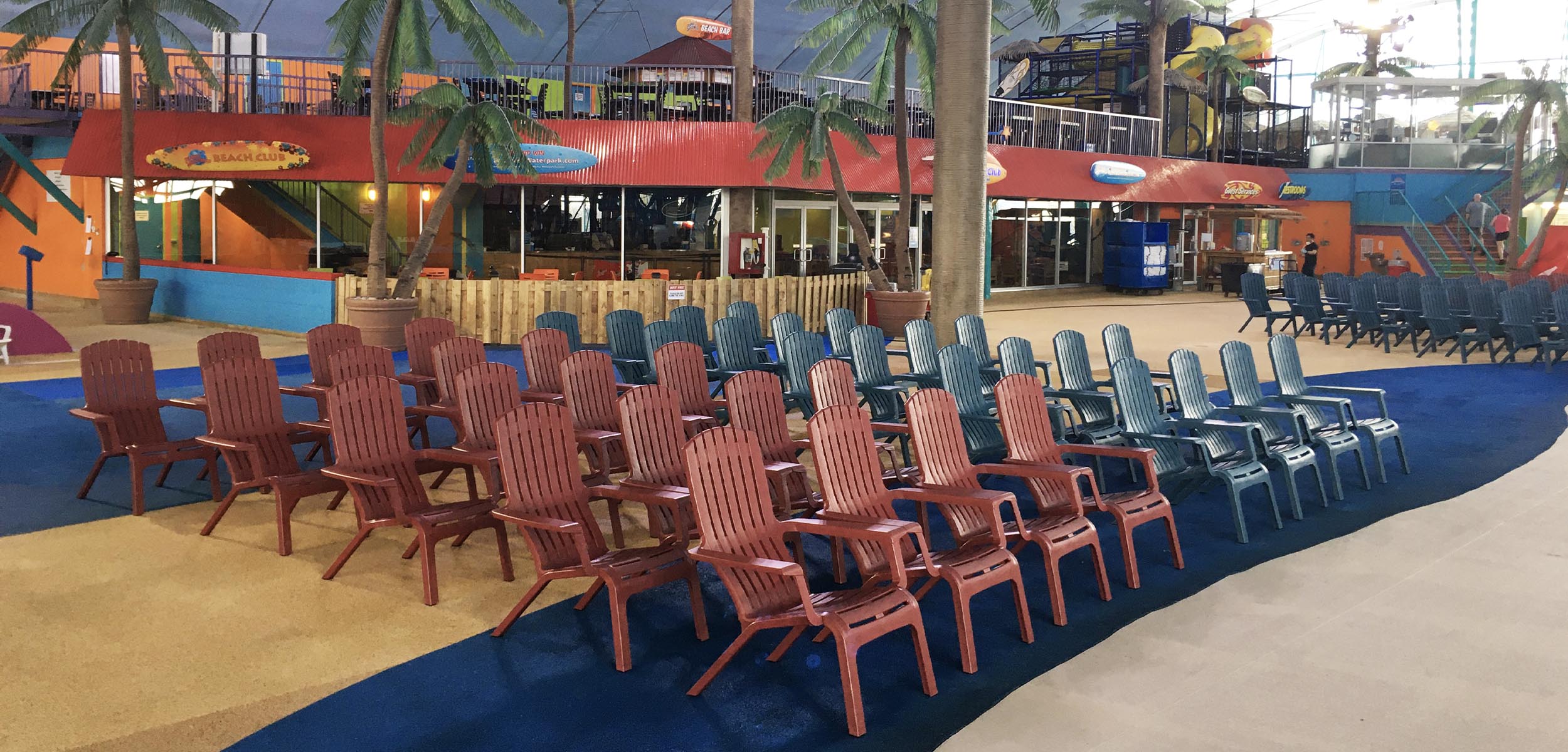 A group of Westport Adirondack chairs at an indoor waterpark