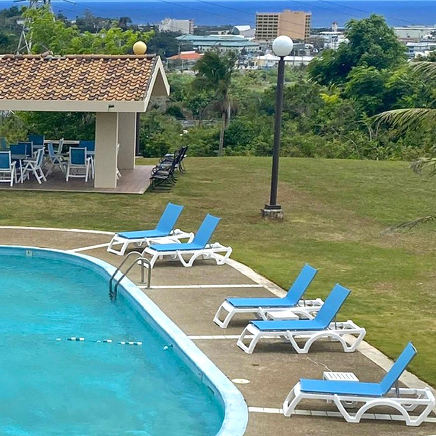 Jamaica Beach Chaise Lounges look poolside at the Holiday Tower Condos in Guam