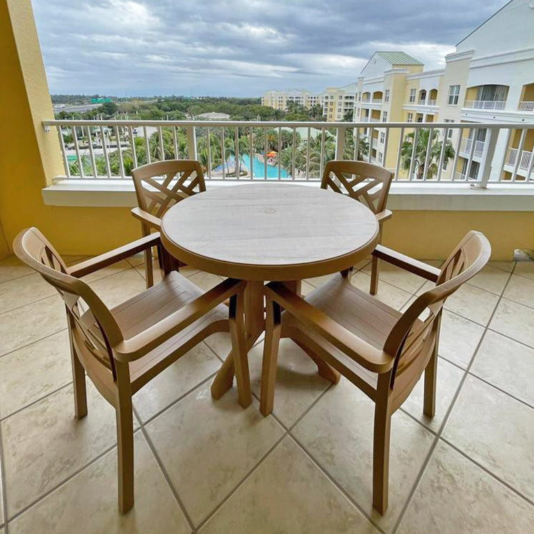 Grosfillex Aquaba Table overlooks the pool on the Vacation Village balcony