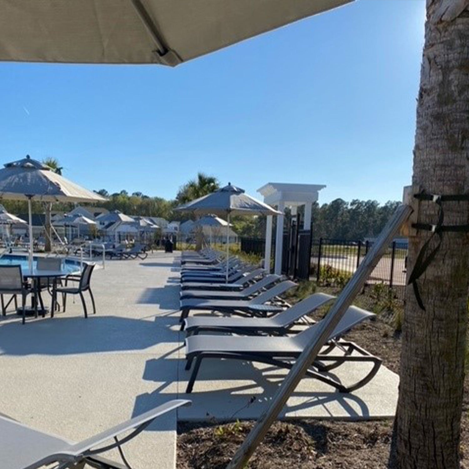 Sunset Chaises under umbrellas at Watson Hill HOA