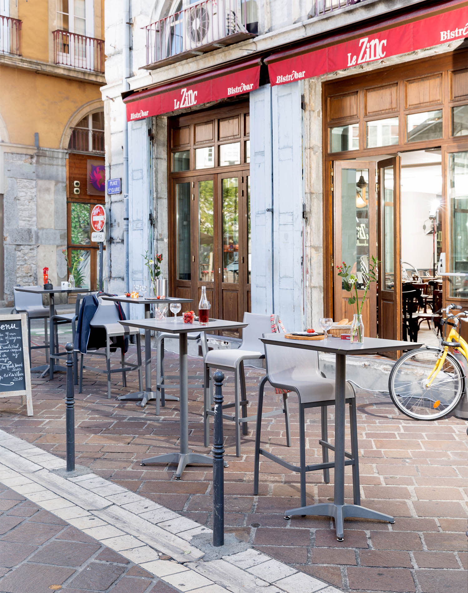 Armless Barstools and Bar Height Tables on an outdoor bistro patio