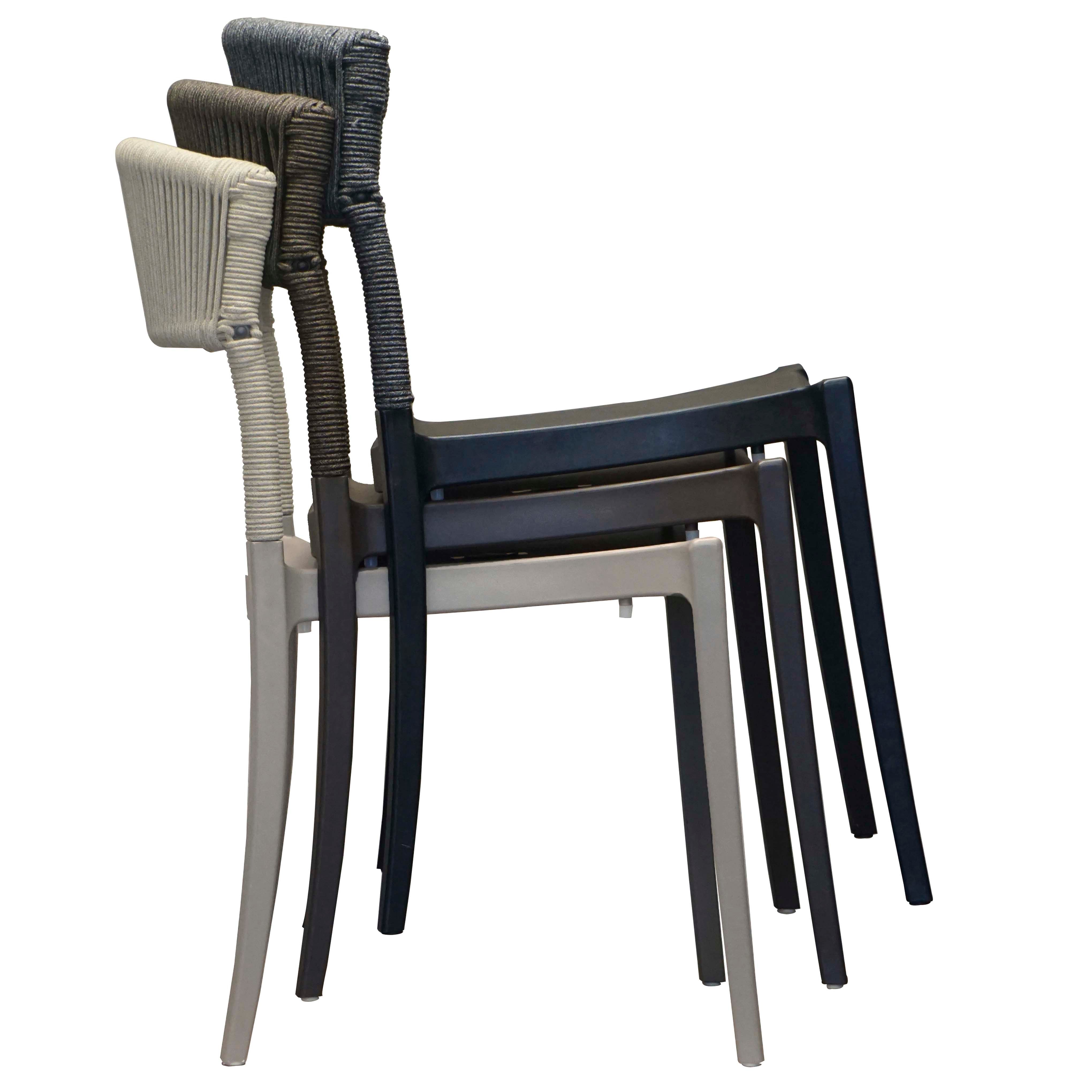 Stack of three chairs in different colors on a white background